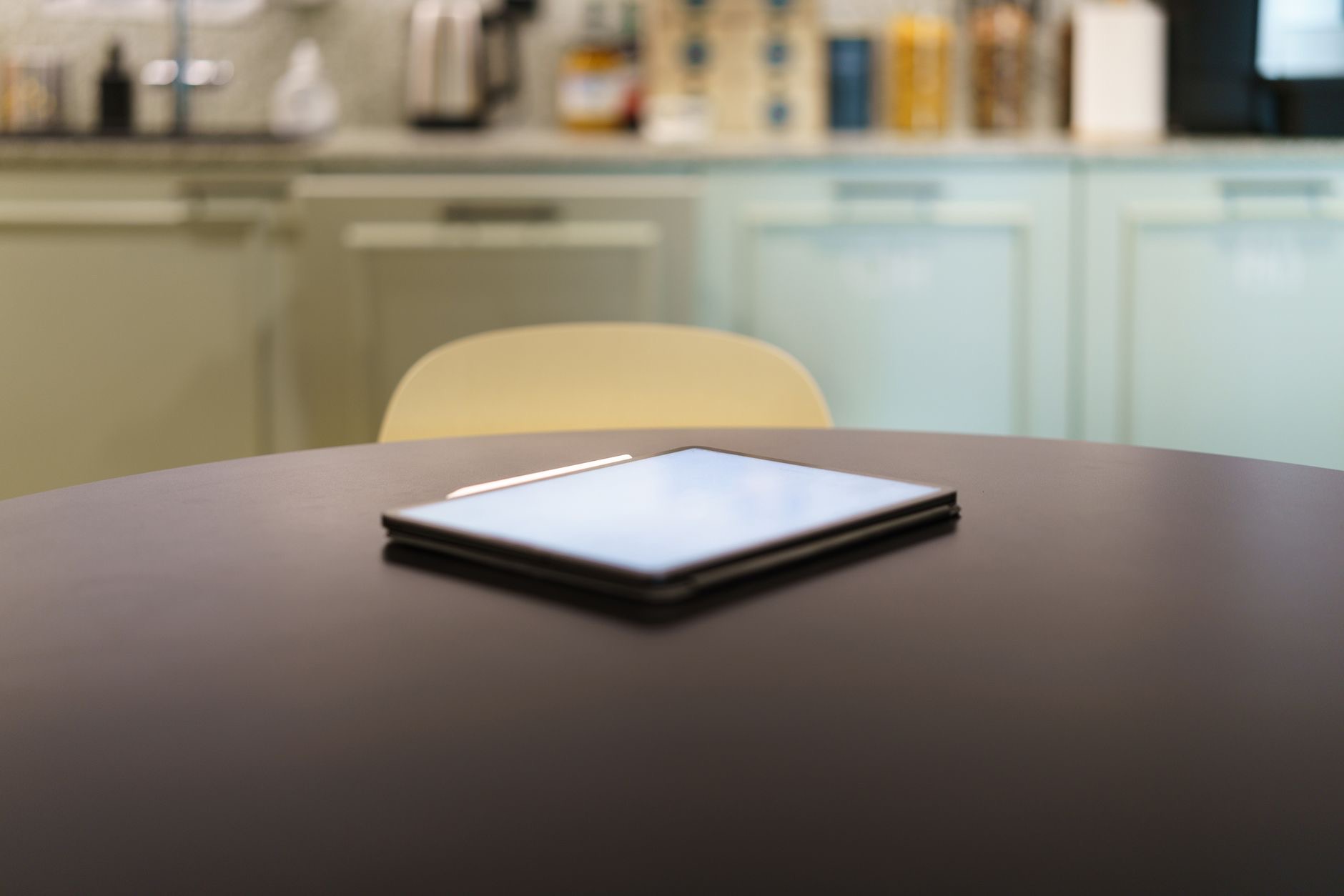 A tablet on a stand in a kitchen