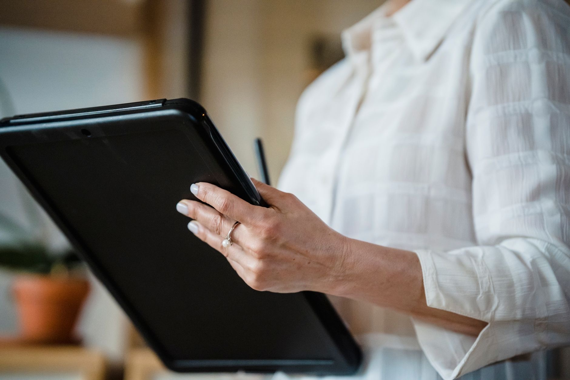 Person holding a compact tablet