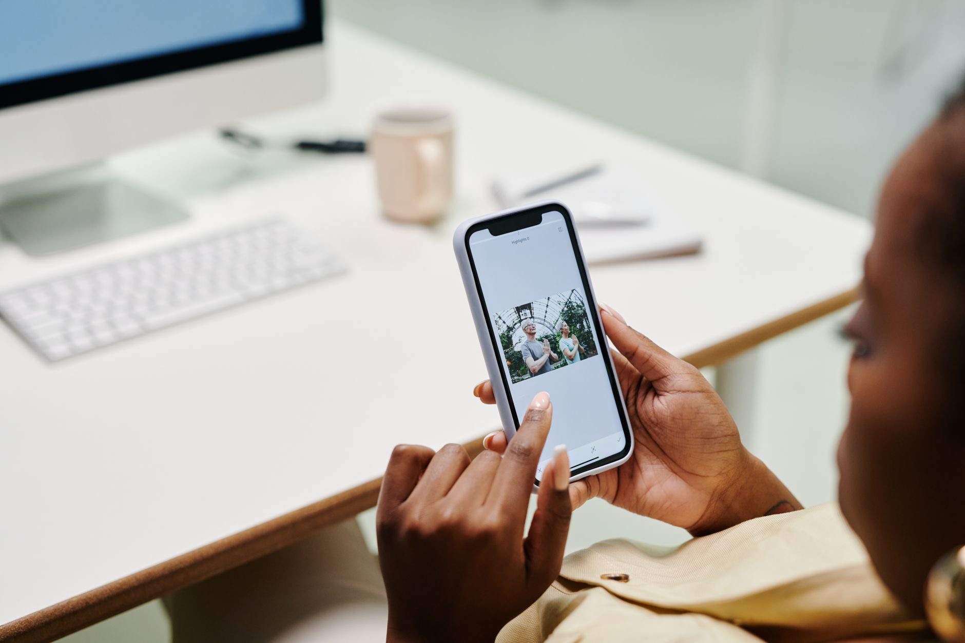 Someone using an iPhone at a desk