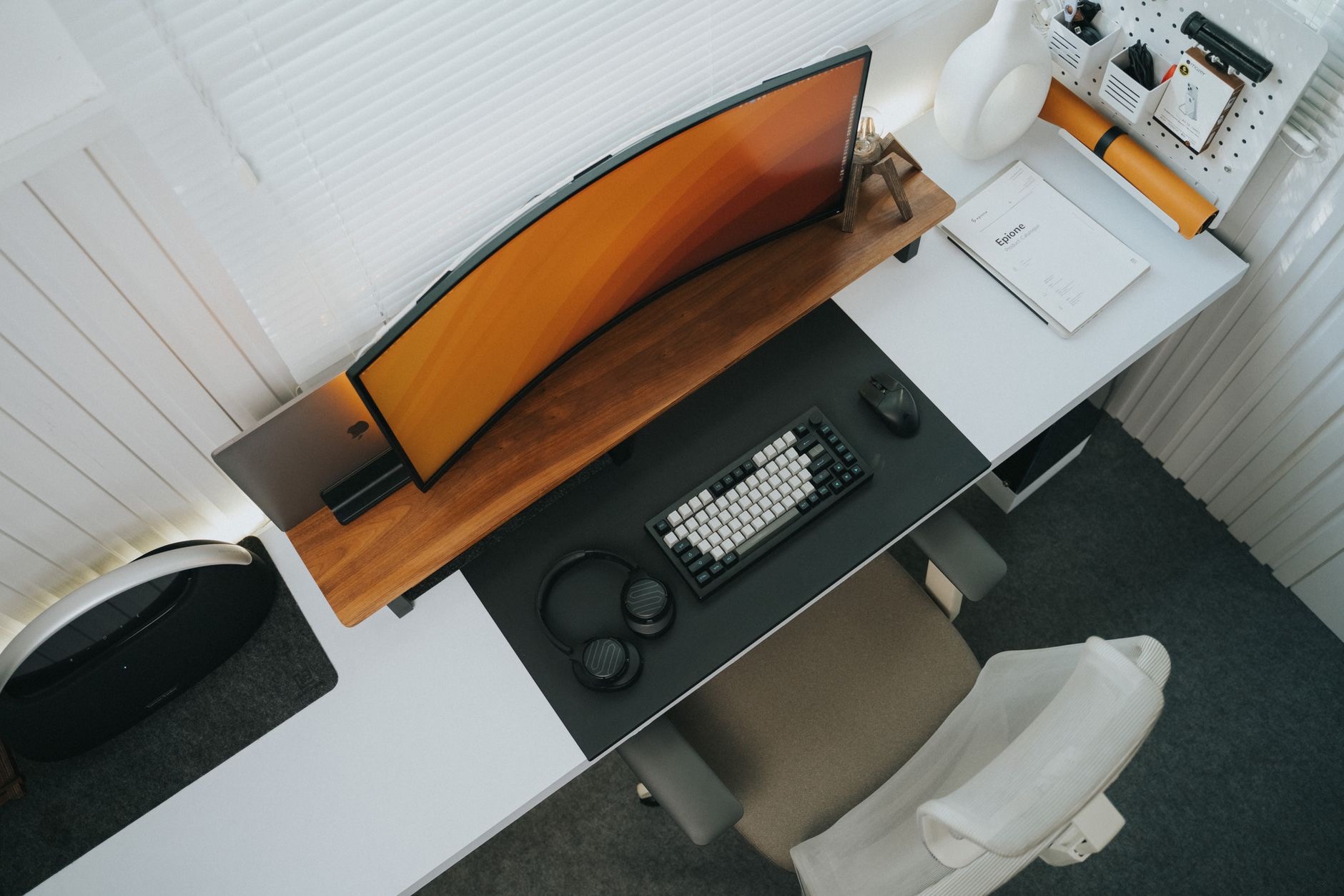 A desk setup with stand and keyboard