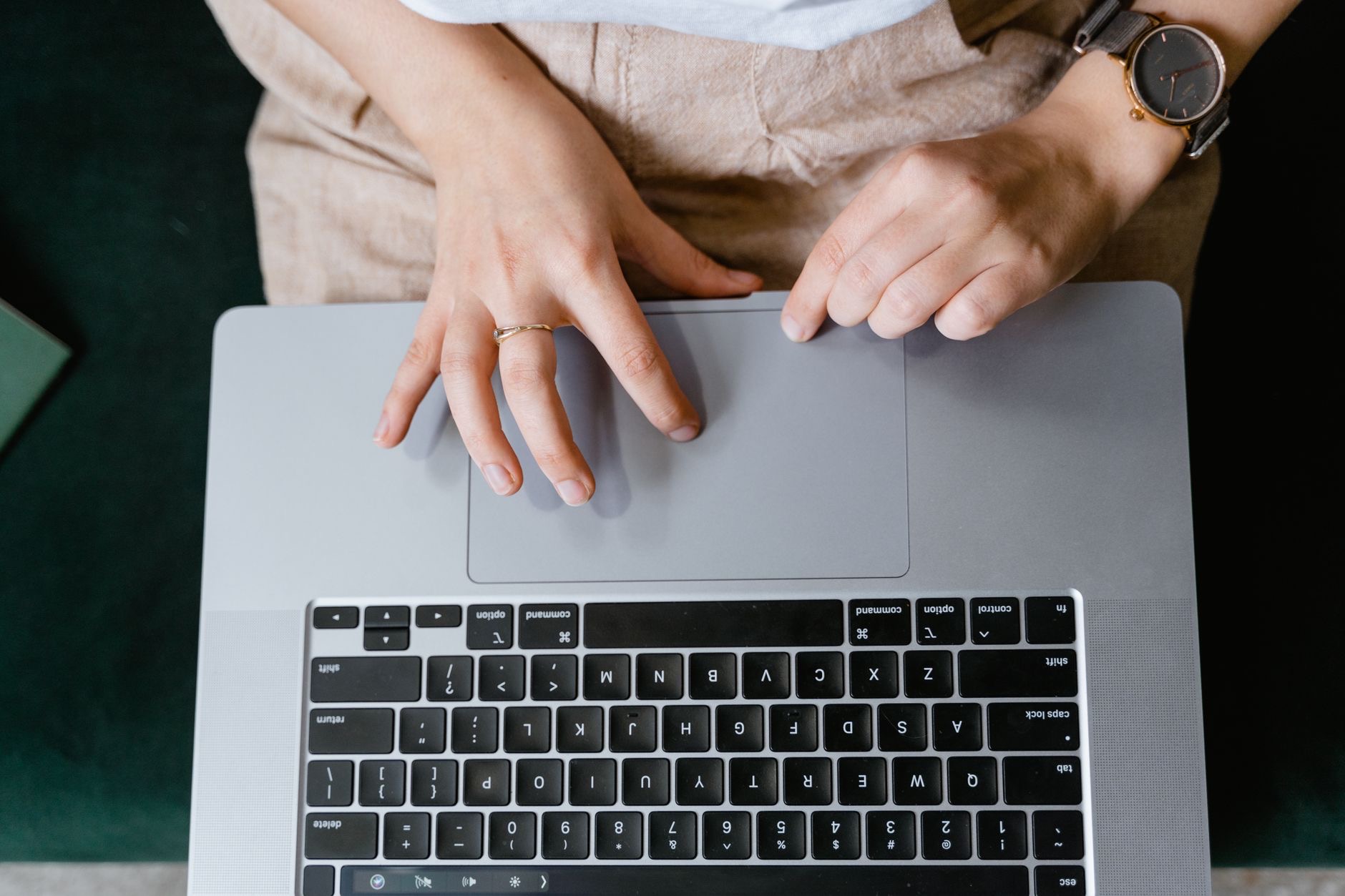 A hand gesturing on a trackpad