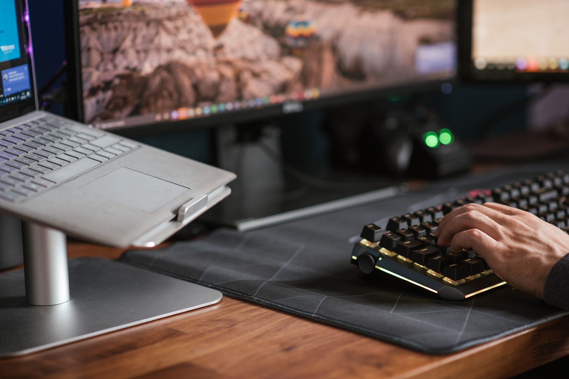 A laptop and a compact desktop Mac