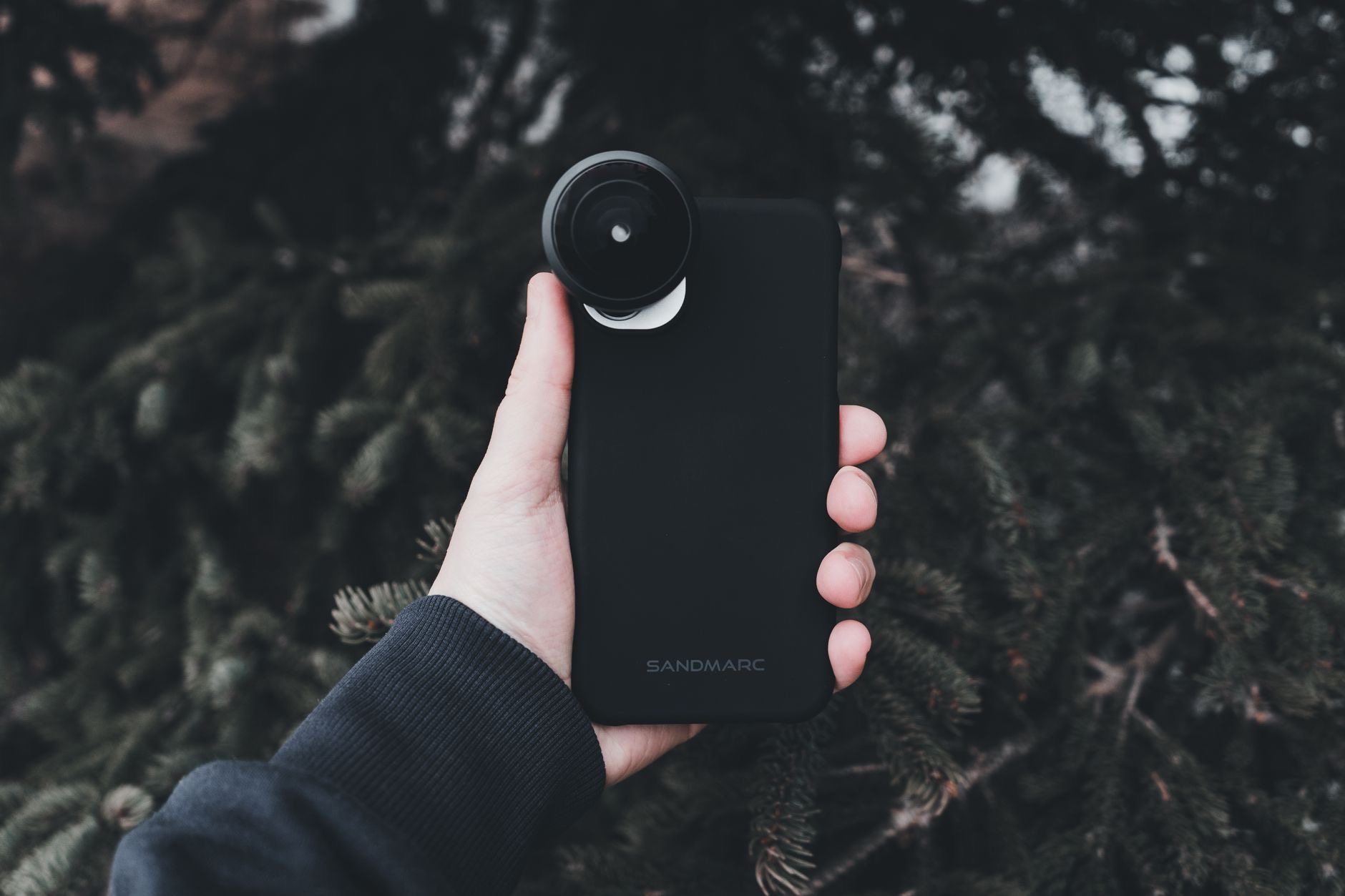 Person attaching an accessory to a phone