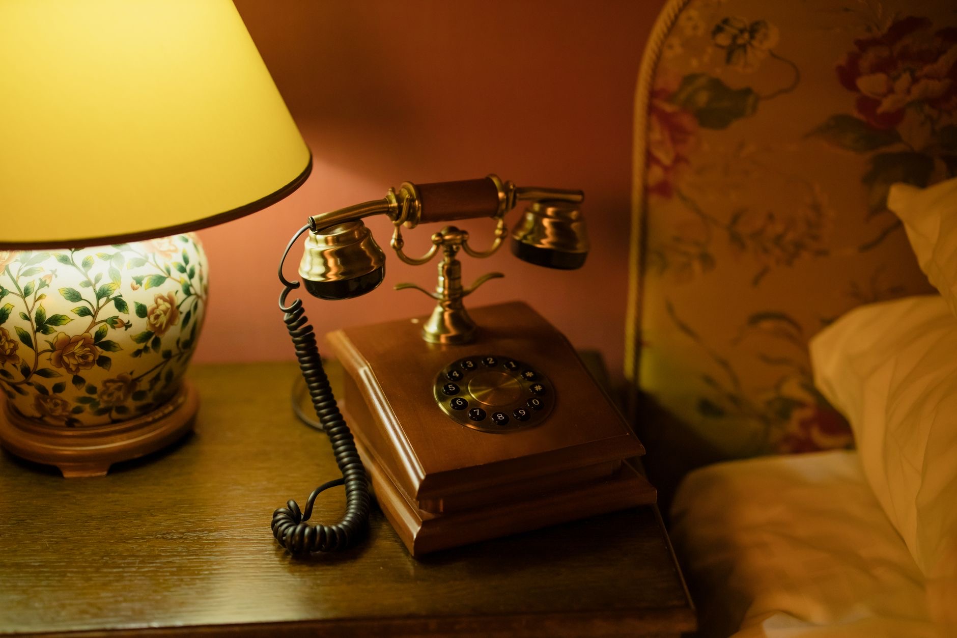 A bedside setup with a charging phone